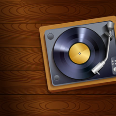 Vinyl record player on wooden background