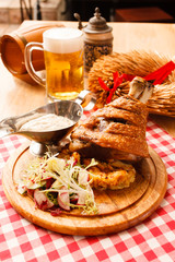 eisbein with braised cabbage, salad and beer