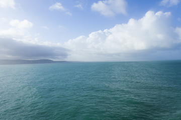 Sea view leaving Dover, with blue sky and clouds