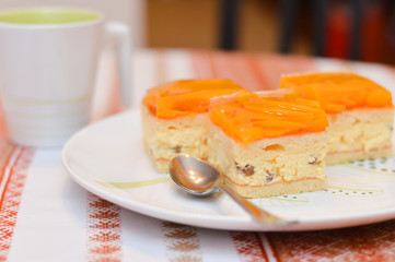 delicious slice of apricot cake lays on a white plate