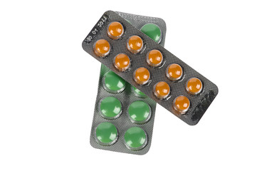 Green and orange pills in blisters on white background