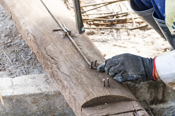 worker bending steel for construction job