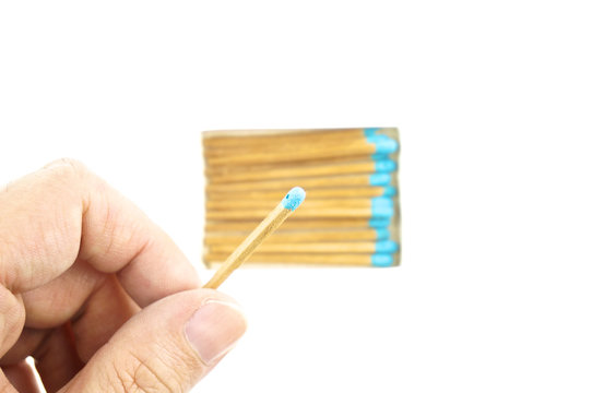 Hand hold blue matchstick for lit and box isolated