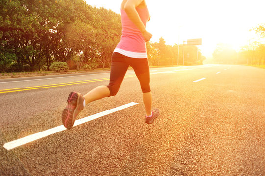 fitness woman runner athlete running on sunrise road