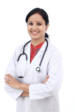 Young female doctor against white background