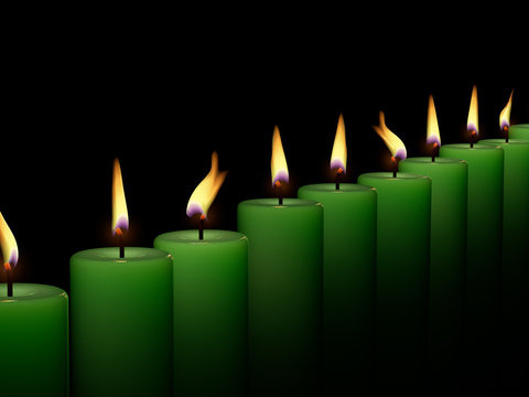Closeup of burning many candle isolated on black background