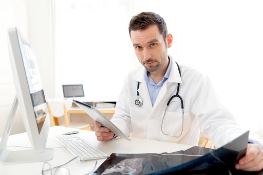 Portrait of a young doctor using tablet at work