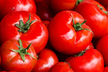 Group of fresh tomatoes background. Ripe red tomatoes on a marke