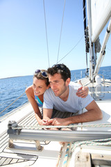 Couple relaxing on sailboat deck