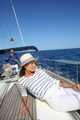 Beautiful woman with hat enjoying cruising on boat