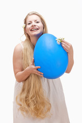 Young Woman with Long Blond Hair and Large Blue Egg.