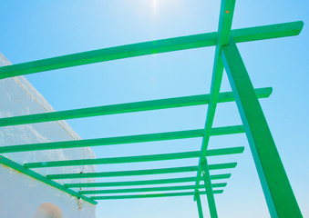 wooden green coloured pergola in Amorgos island in Greece