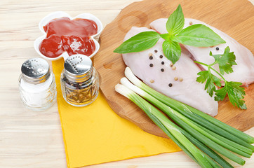 Raw chicken breasts on cutting board