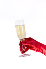 Female hand in red opera glove holding champagne glass