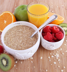 Healthy breakfast of oatmeal, fruit and orange juice