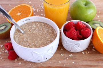 Healthy breakfast of oatmeal, fruit and orange juice