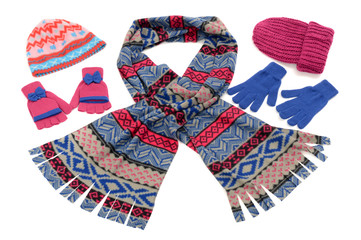 Pink and blue winter accessories isolated.Wool scarf,gloves,hats