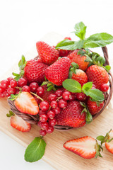 Fresh strawberry and redcurrant on white