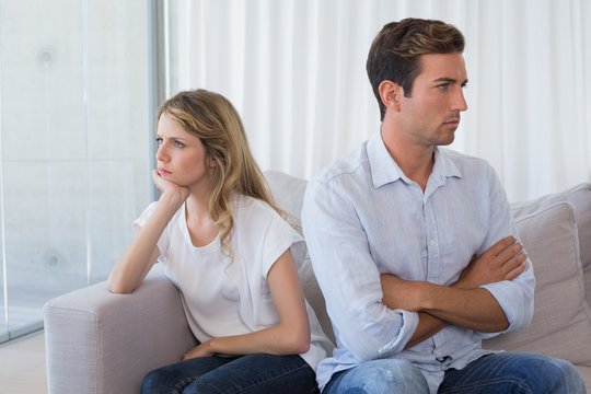 Couple not talking after an argument in living room