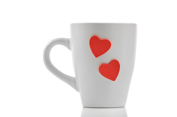 Cup with red heart isolated on white
