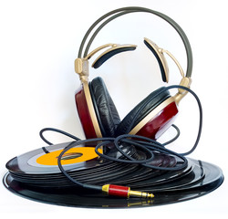headphones arranged over some old 45 rpm records