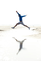 Man running and jumping at the beach