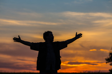 Fototapeta premium silhouette of man standing in a field