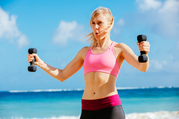 Fitness woman with barbells working out