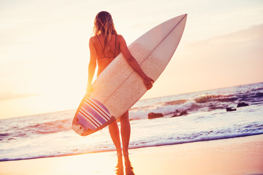 Surfer Girl On The Beach At Sunset