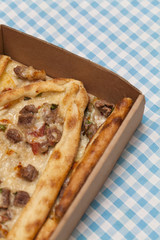 Cubed meat Turkish pitta in open box