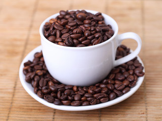 Coffee mug full of coffee beans