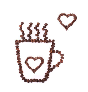 Coffee mug full of coffee beans with heart shapes