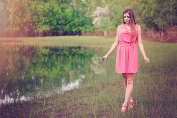 Girl walking at the edge of pond
