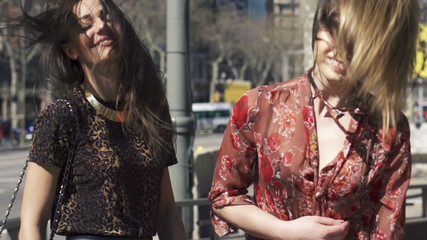 Two beautiful women with long beautiful hair in the city
