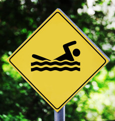 Yellow traffic label with swimming pictogram