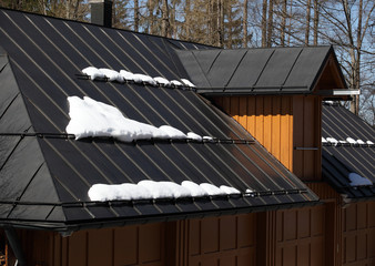 Fototapeta premium Metal roof of house with snow
