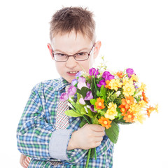 Handsome boy with flowers in hands