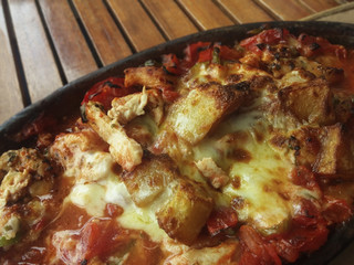 baked chopped chicken and garnish in ceramics pot