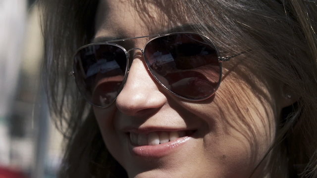 Portrait of young beautiful happy woman in sunglasses