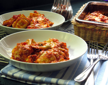 Baked ravioli casserole served in bowls.