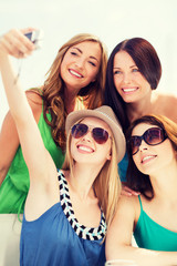 girls taking photo in cafe on the beach
