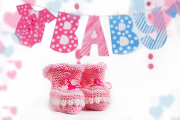Pink bootees and baby word garland