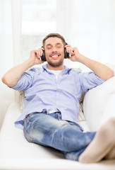 smiling young man in headphones at home