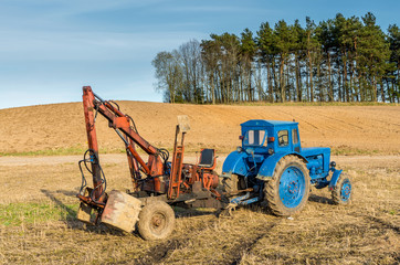 Old russian tractor with loader