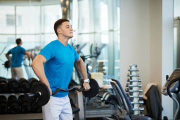 Fototapeta premium man doing exercises with barbell