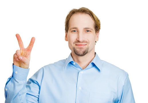 Portrait middle aged man showing victory, peace or two sign