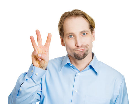 Third place. Man shows three fingers, unhappy, white background 