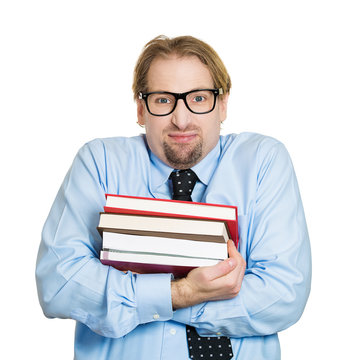 Nerdy shy, young guy, student with glasses holding books