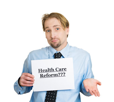 Confused man holding healthcare reform? sign
