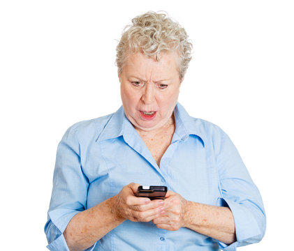 Shocked elderly woman looking on phone. Bad news text or email